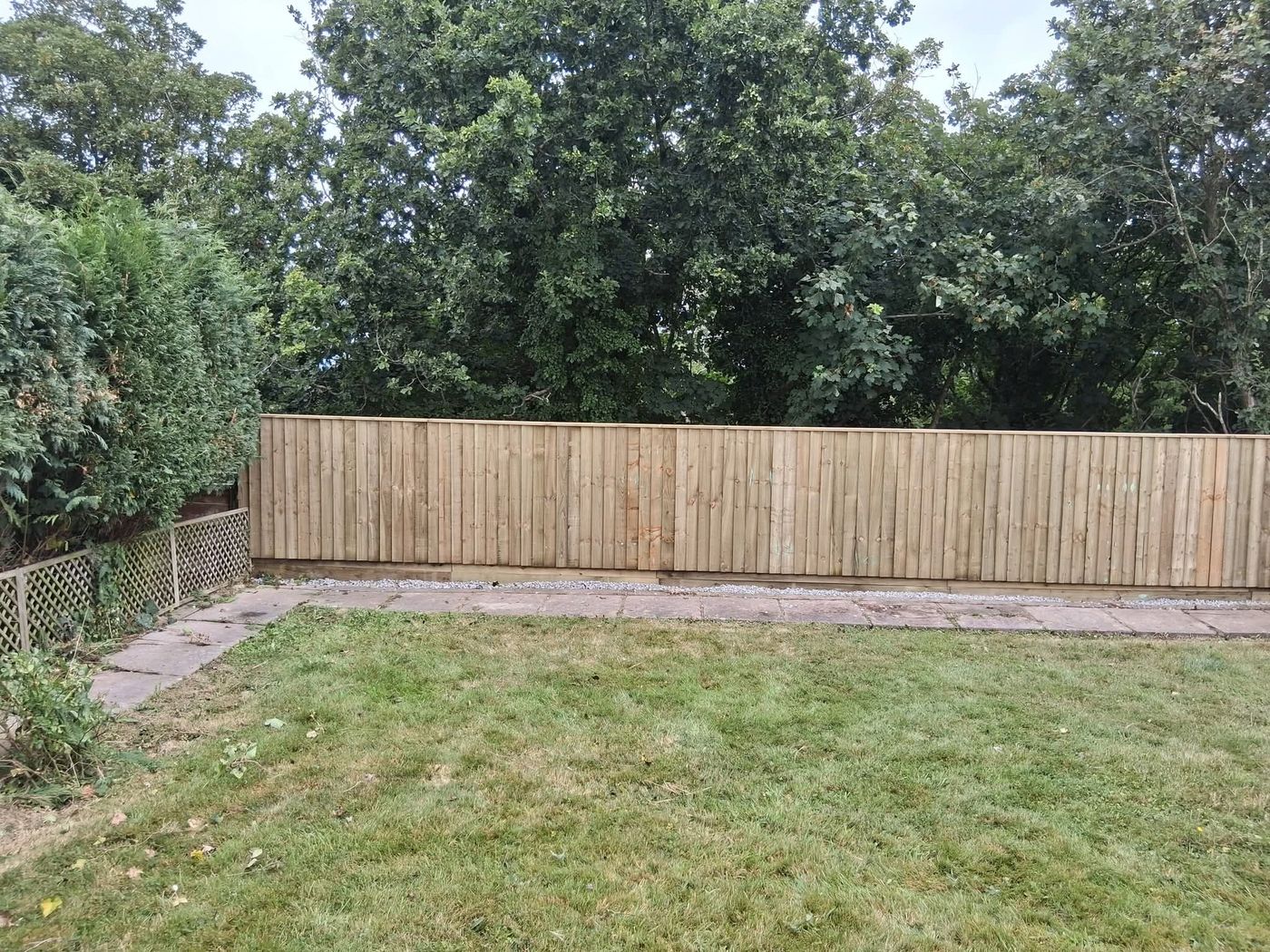 Timber close board fencing installed along a garden boundary