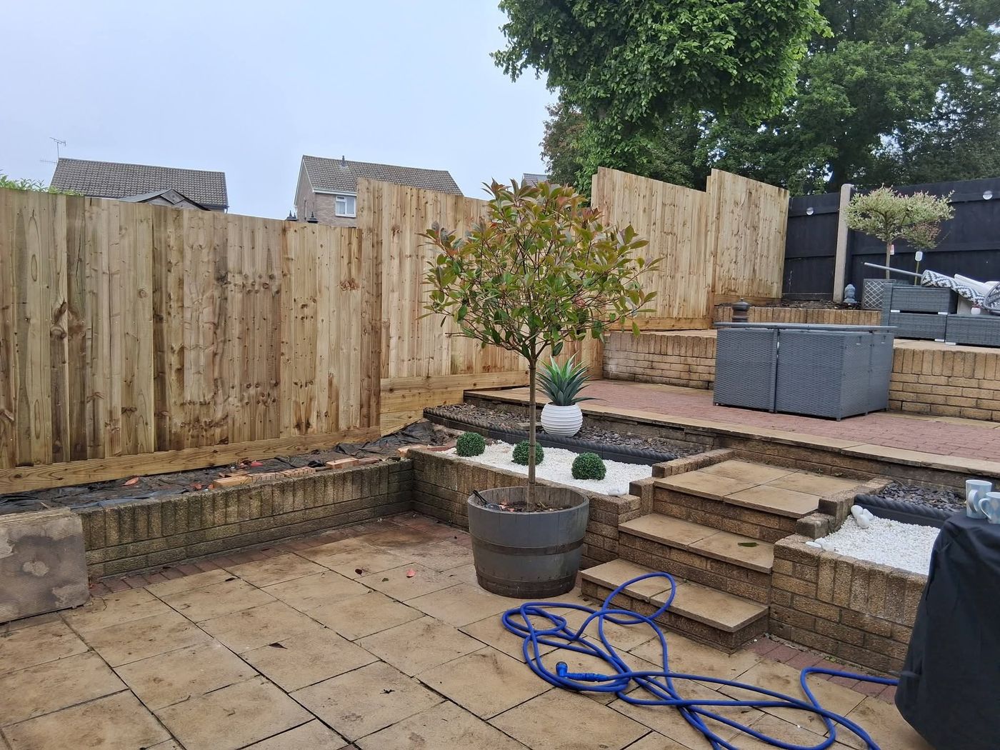 Timber fence panels fitted between posts along a garden boundary